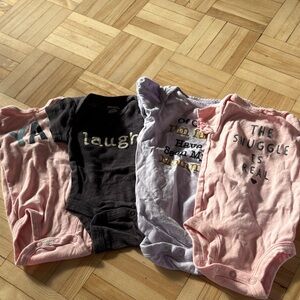 Set of Baby Onesies in Pink, Black, and Purple